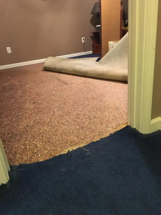 Carpet pad removal revealing water damage during Drying & Dehumidification in Salem Lakes